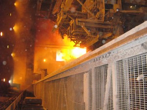 Overhead crane used to charge furnace at Steel mill